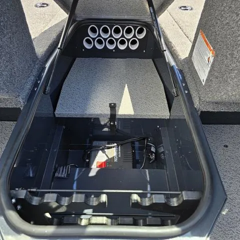 Slide: The Image of 2025 Lund 1775 Adventure Sport boat storage compartment with rod holders and battery. - 8