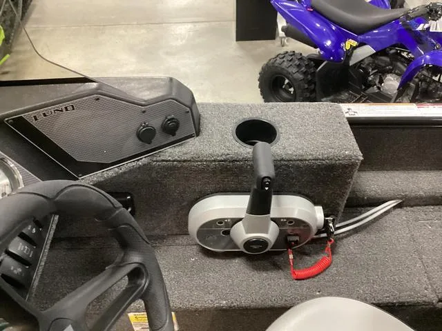 Slide: The Image of 2024 Lund 1650 Rebel XL SS boat interior with steering wheel and control panel. - 11