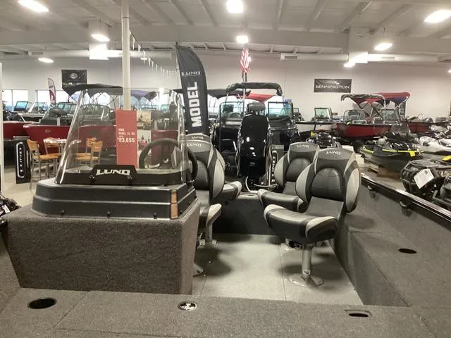Slide: The Image of 2024 Lund 1650 Rebel XL SS boat interior with seating, displayed in a showroom. - 12
