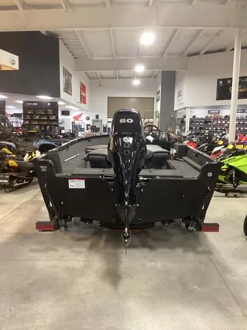 Slide: The Image of 2024 Lund 1650 Rebel XL SS boat in showroom, rear view with motor. - 3