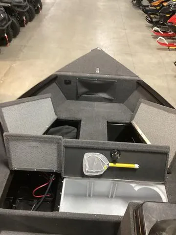 Slide: The Image of 2024 Lund 1650 Rebel XL SS boat interior with storage compartments and fishing net. - 4