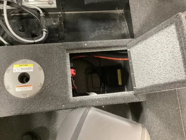 Slide: The Image of 2024 Lund 1650 Rebel XL SS boat interior, showing storage compartment and wiring. - 6