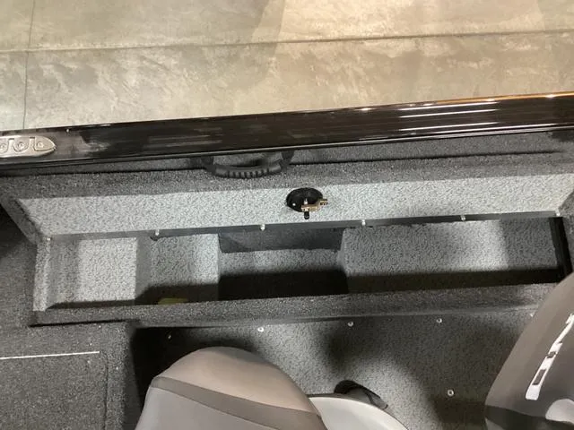 Slide: The Image of 2024 Lund 1650 Rebel XL SS boat interior storage compartment with gray textured finish. - 8