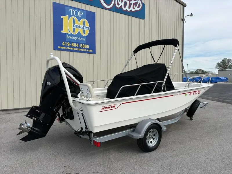 Slide: The Image of 2021 Boston Whaler 170 Montauk boat on trailer, parked outside dealership. - 3