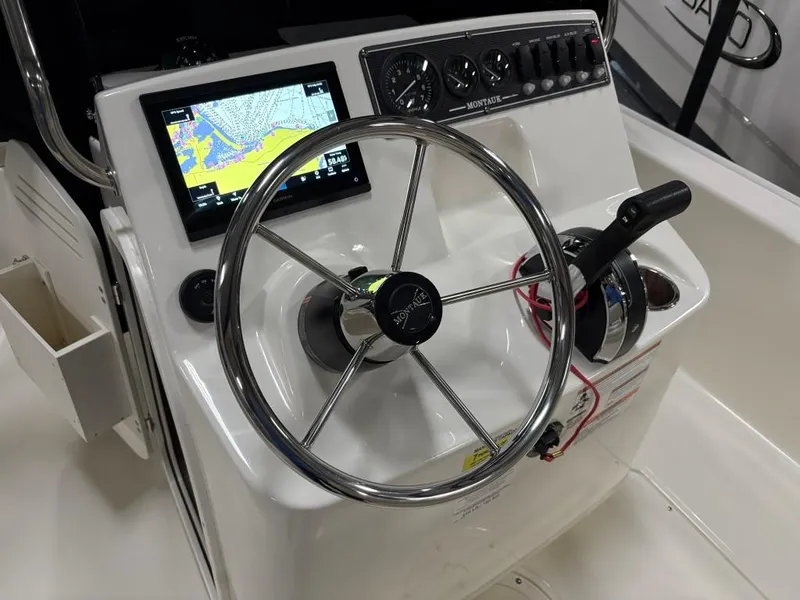 Slide: The Image of 2021 Boston Whaler 170 Montauk boat console with steering wheel and navigation display. - 9
