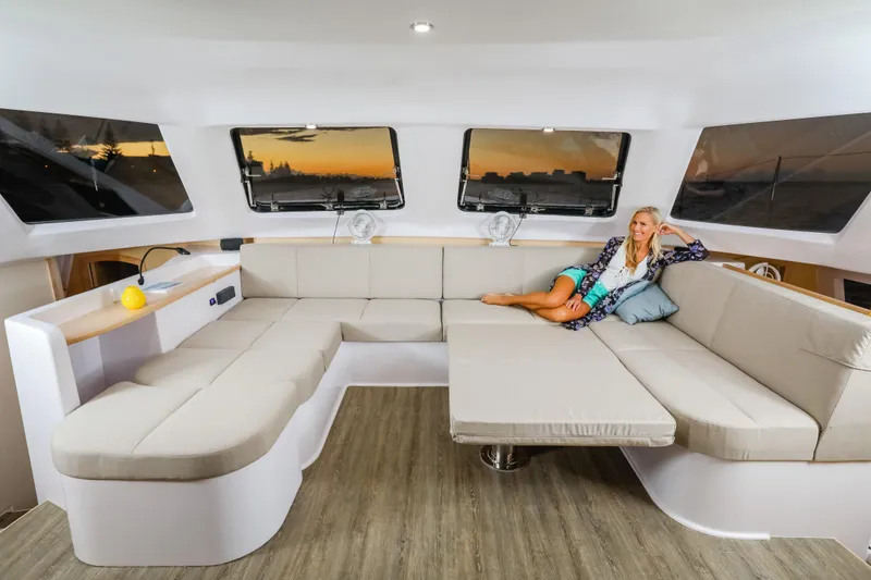 Slide: The Image of Luxurious interior of 2025 Seawind 1260 catamaran with spacious seating and sunset view. - 19