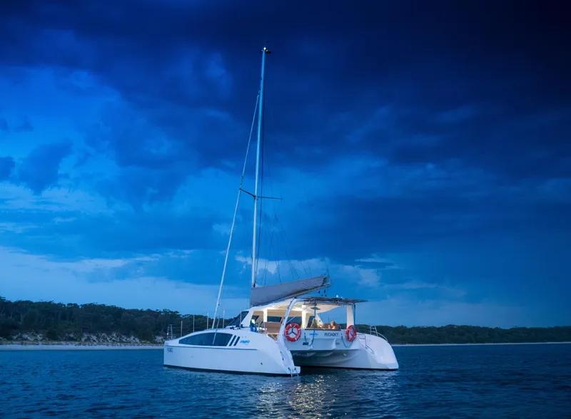 Slide: The Image of 2025 Seawind 1260 catamaran sailing at dusk on calm waters. - 7