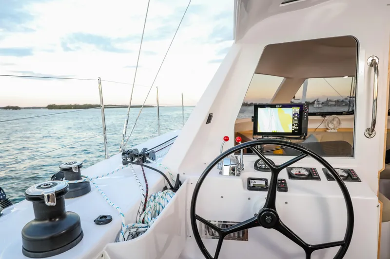 Slide: The Image of 2025 Seawind 1260 catamaran cockpit with steering wheel and navigation system at sea. - 8