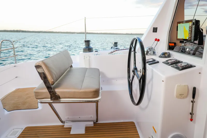 Slide: The Image of Helm of 2025 Seawind 1260 catamaran with modern controls and ocean view. - 9