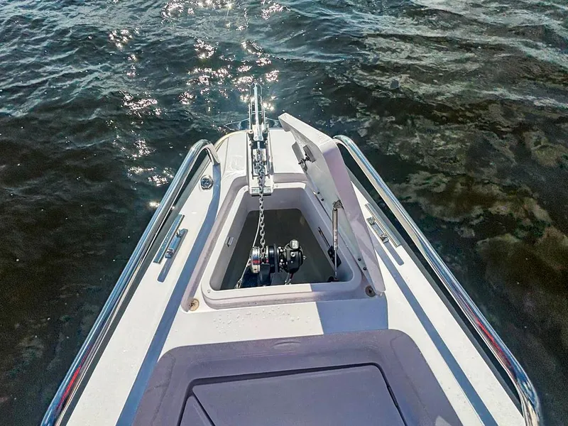 Slide: The Image of Bow view of 2022 Axopar 28 CABIN boat with anchor compartment open. - 11