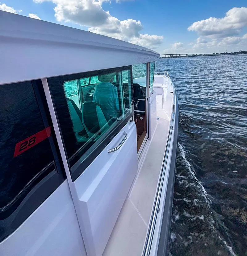 Slide: The Image of 2022 Axopar 28 CABIN cruising on a sunny day with clear skies. - 12