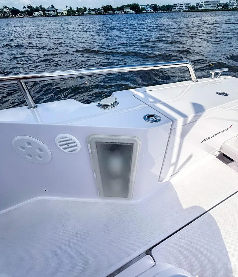 Slide: The Image of 2022 Axopar 28 CABIN boat deck with railing, on calm water. - 17