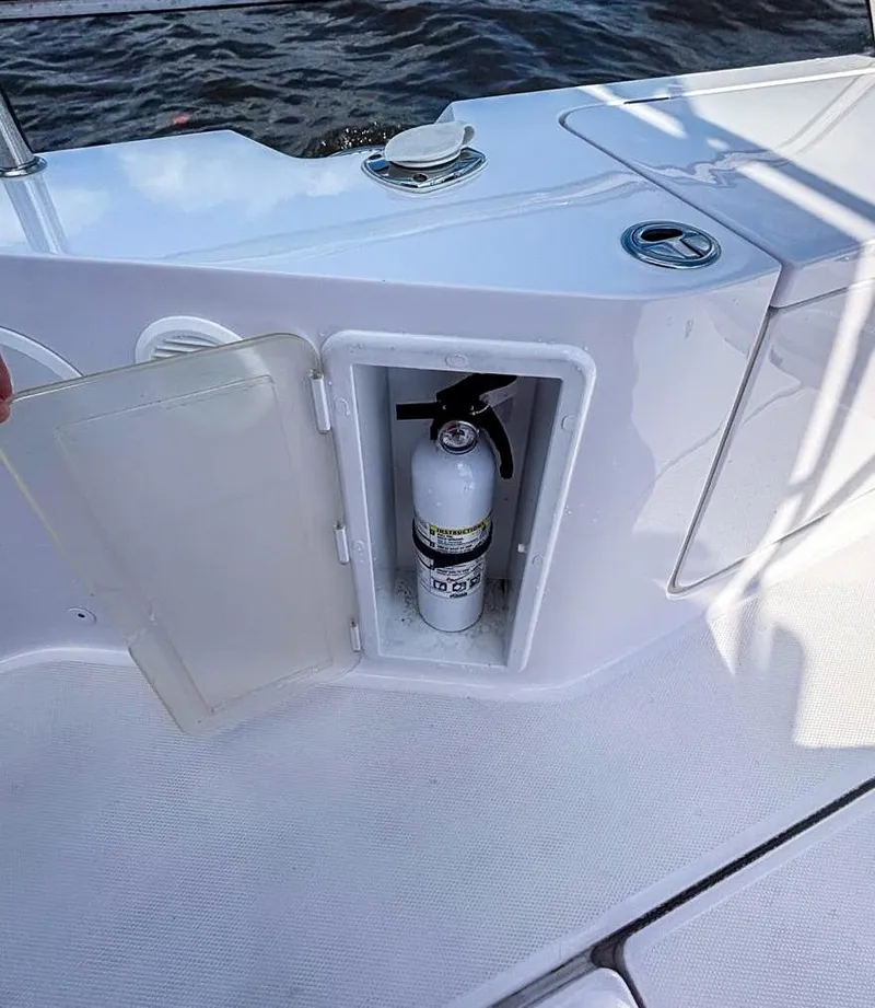 Slide: The Image of 2022 Axopar 28 CABIN boat with onboard fire extinguisher compartment. - 18