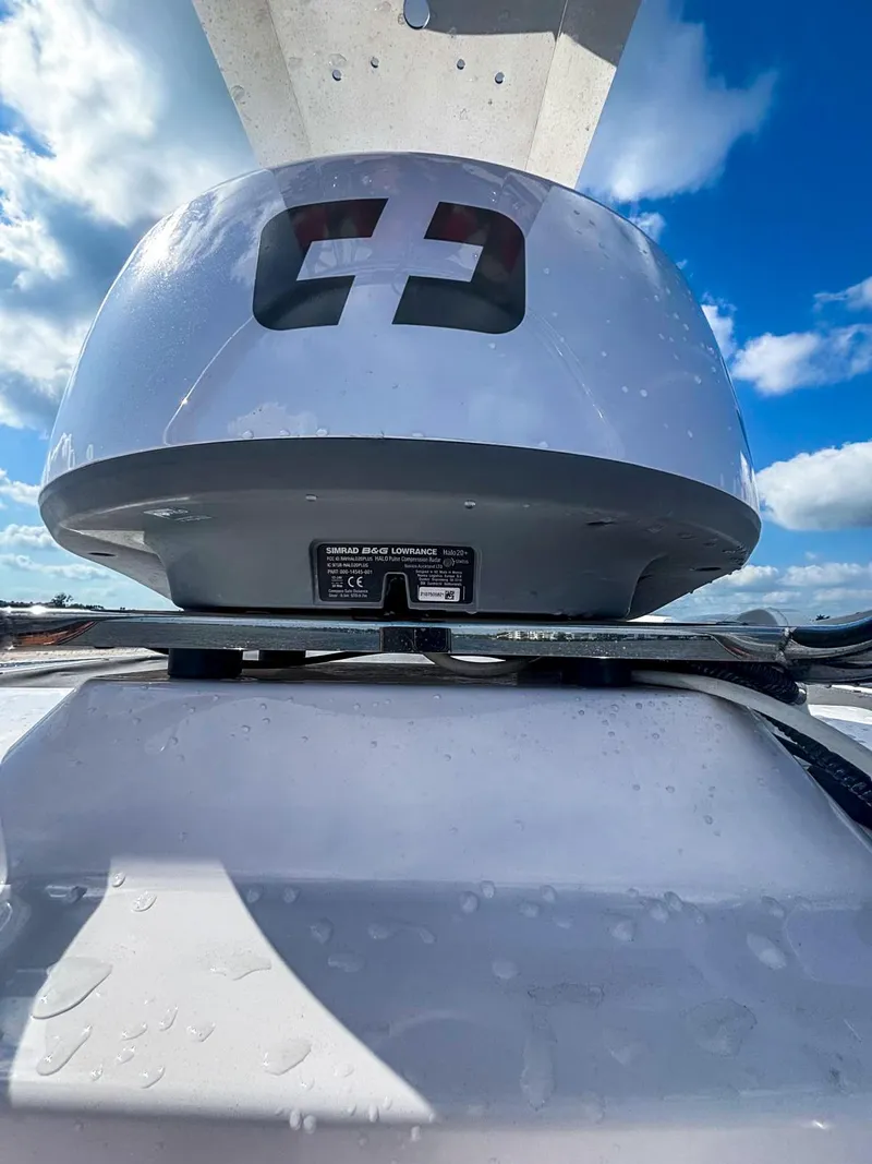 Slide: The Image of 2022 Axopar 28 CABIN boat radar against a bright blue sky. - 19