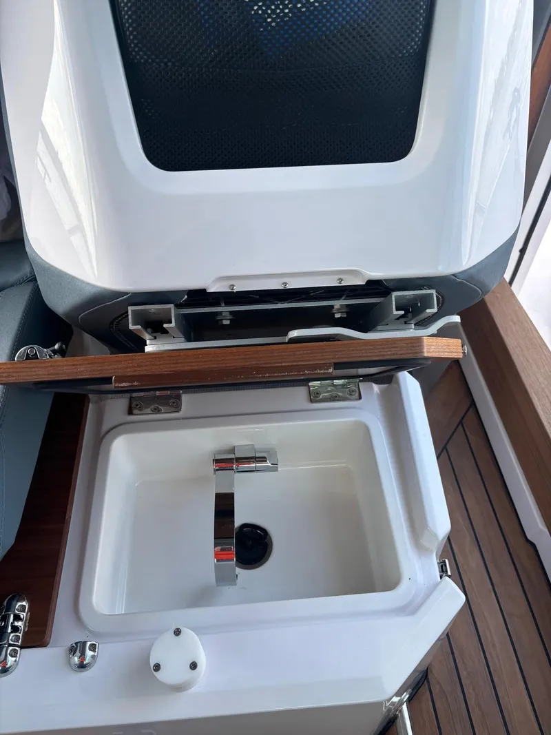 Slide: The Image of 2022 Axopar 28 CABIN boat sink with wooden cover and modern faucet. - 6