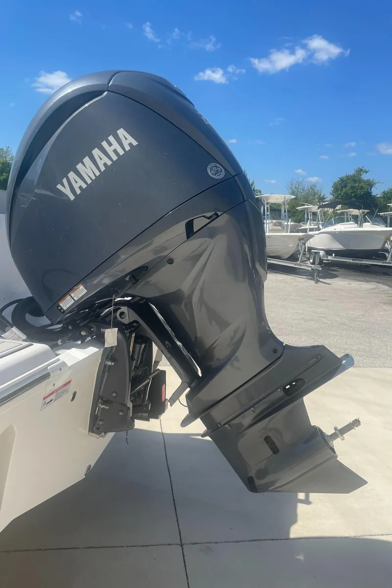 Slide: The Image of 2023 Sea Fox 228 Commander with Yamaha outboard motor, parked outdoors. - 16