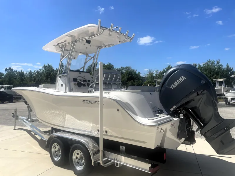 Slide: The Image of 2023 Sea Fox 228 Commander boat on trailer with Yamaha engine, under clear blue sky. - 4