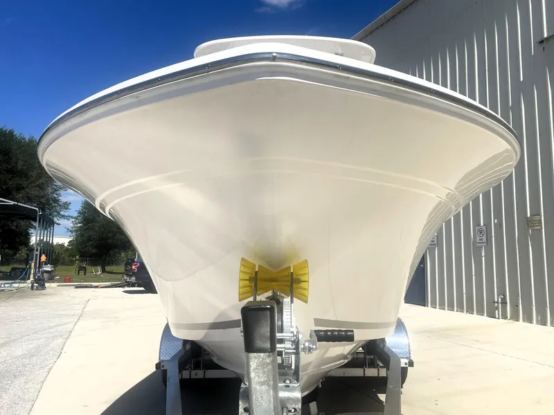 Slide: The Image of 2023 Sea Fox 228 Commander boat on trailer, front view, outdoors. - 7