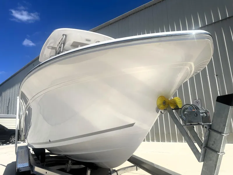Slide: The Image of 2023 Sea Fox 228 Commander boat on trailer, viewed from the front under a clear blue sky. - 8