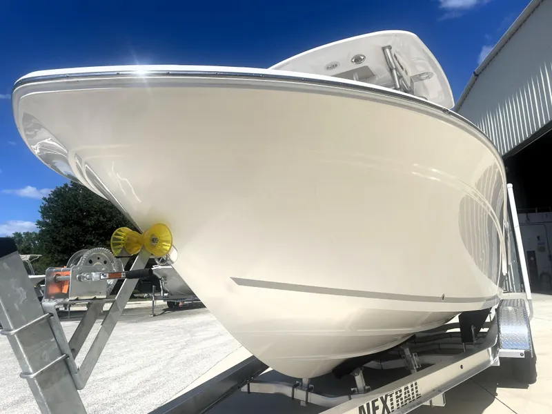 Slide: The Image of 2023 Sea Fox 228 Commander boat on trailer, viewed from the front under a clear blue sky. - 9