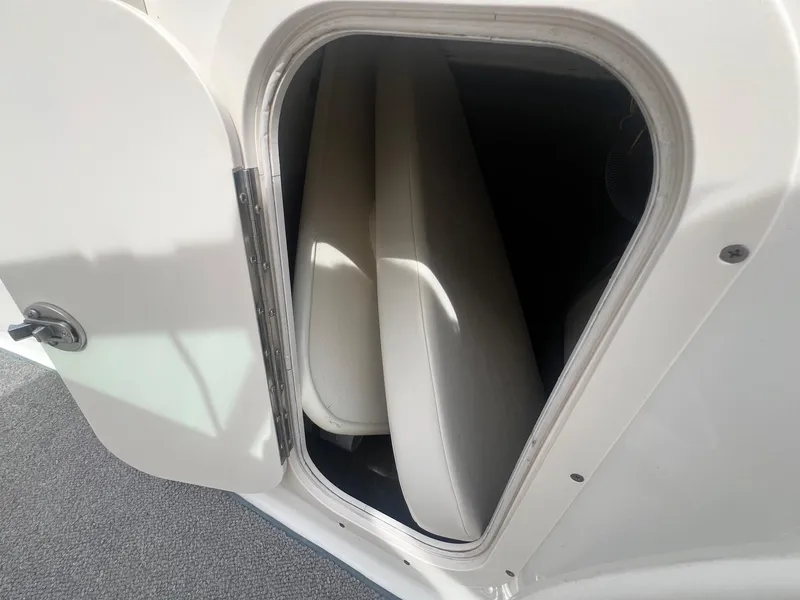 Slide: The Image of Storage compartment in a 2008 Chaparral 220 SSi boat, showing interior seating. - 15