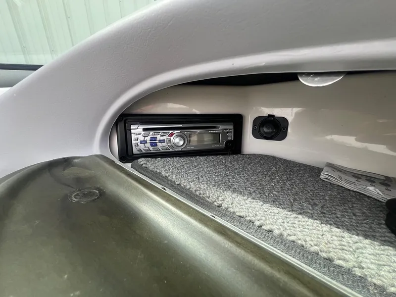 Slide: The Image of 2008 Chaparral 220 SSi boat stereo system with carpeted interior detail. - 17