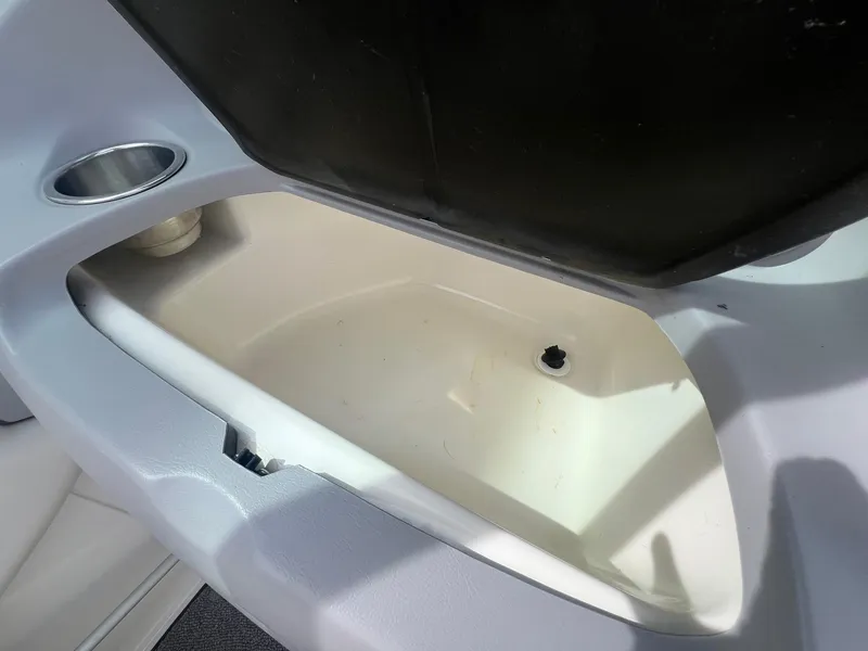 Slide: The Image of Open storage compartment in 2008 Chaparral 220 SSi boat with cup holder. - 18
