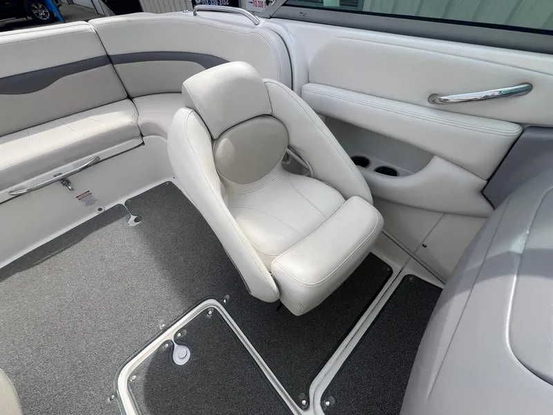Slide: The Image of 2008 Chaparral 220 SSi boat interior with white seating and gray carpet. - 19