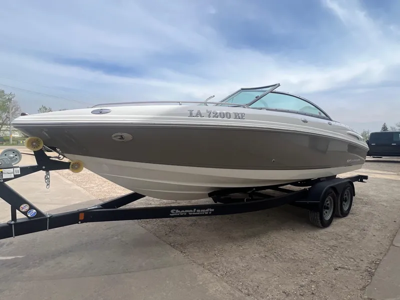 Slide: The Image of 2008 Chaparral 220 SSi boat on trailer, parked outdoors under a cloudy sky. - 2