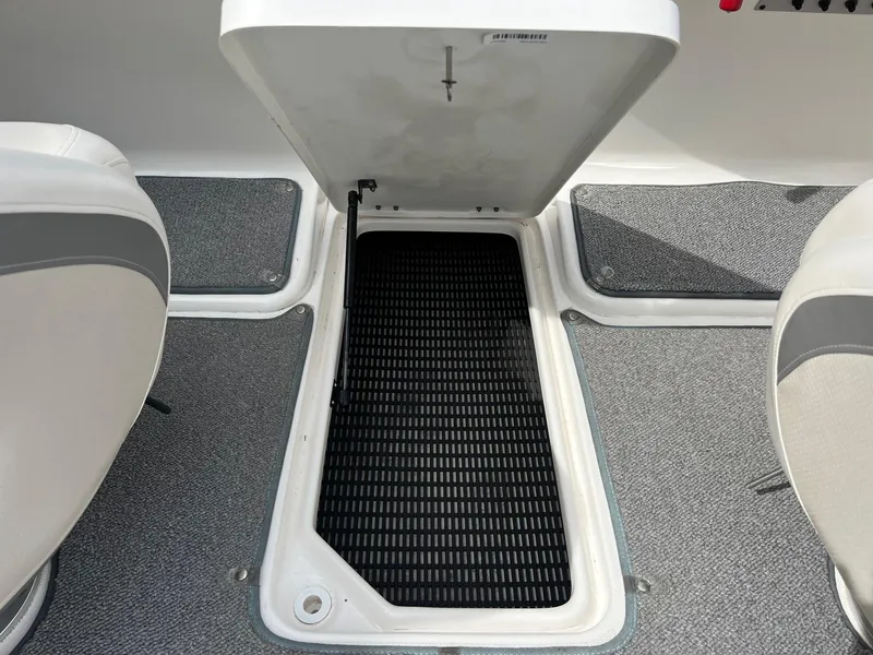 Slide: The Image of Open storage compartment on 2008 Chaparral 220 SSi boat, featuring carpeted flooring and seating. - 24