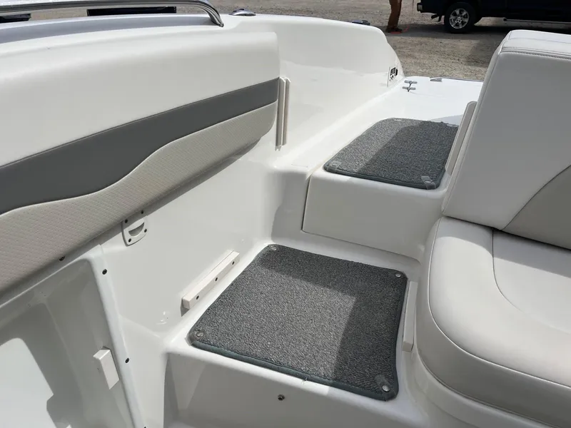 Slide: The Image of 2008 Chaparral 220 SSi boat interior with cushioned seating and carpeted steps. - 25