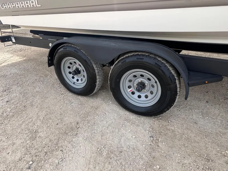 Slide: The Image of Trailer wheels of a 2008 Chaparral 220 SSi boat on gravel surface. - 28
