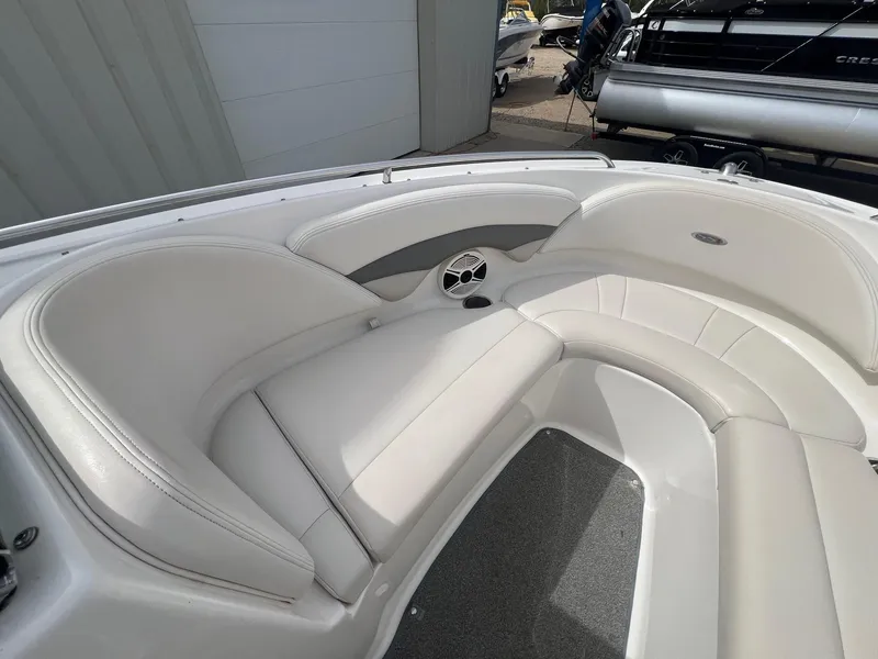 Slide: The Image of 2008 Chaparral 220 SSi boat interior with white leather seating and speaker. - 9