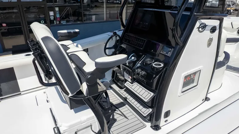 Slide: The Image of 2025 Tidewater 272cc boat interior with modern console and seating. - 10