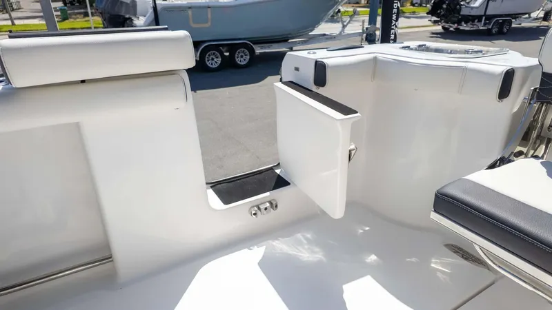 Slide: The Image of 2025 Tidewater 272cc boat interior with open transom door, showcasing sleek design and functionality. - 13