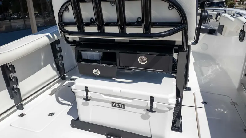 Slide: The Image of 2025 Tidewater 272cc boat interior with Yeti cooler and storage compartments. - 15