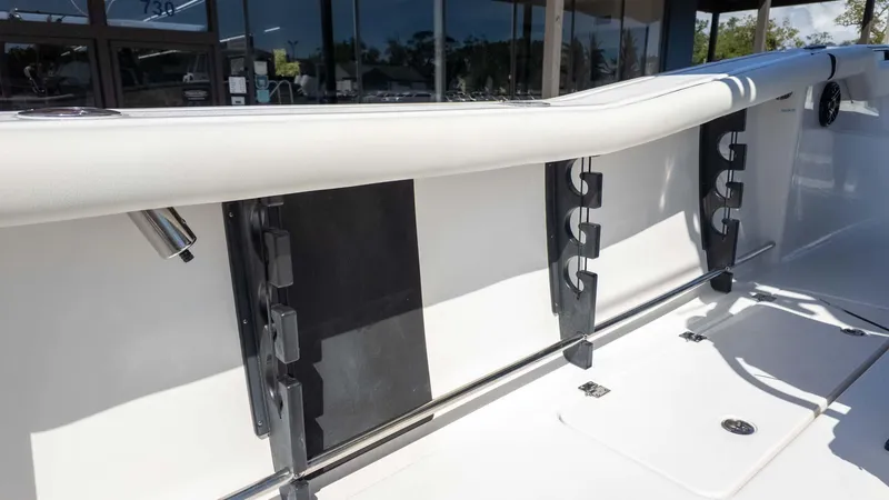 Slide: The Image of 2025 Tidewater 272cc boat interior with rod holders and sleek white finish. - 16