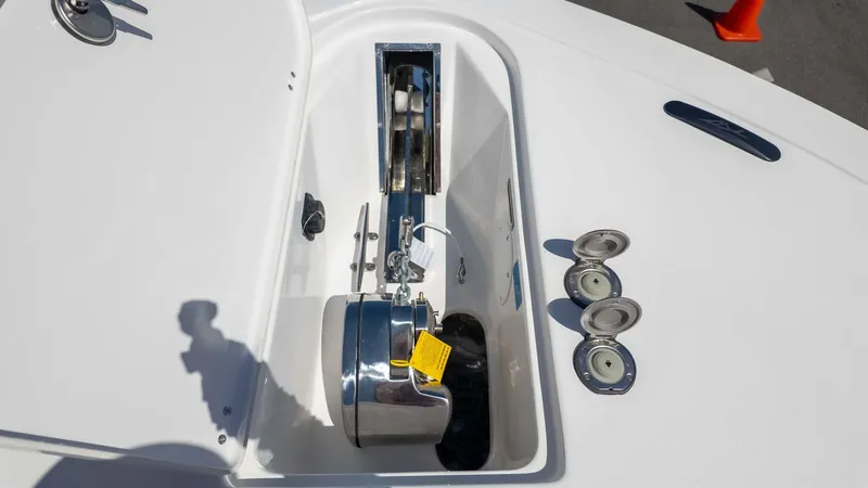 Slide: The Image of 2025 Tidewater 272cc boat anchor compartment with chrome fittings and open hatches. - 24