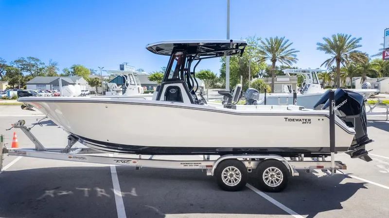 Slide: The Image of 2025 Tidewater 272cc boat on trailer in sunny parking lot. - 5