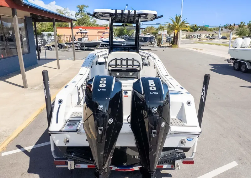 Slide: The Image of 2025 Tidewater 272cc boat with dual 200 V6 engines, parked outdoors. - 6