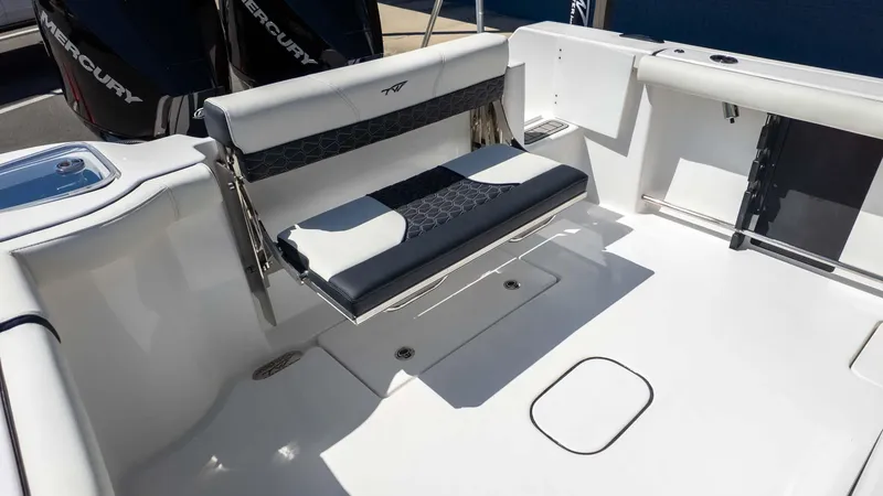 Slide: The Image of 2025 Tidewater 272cc boat interior with foldable seating and Mercury engines. - 8