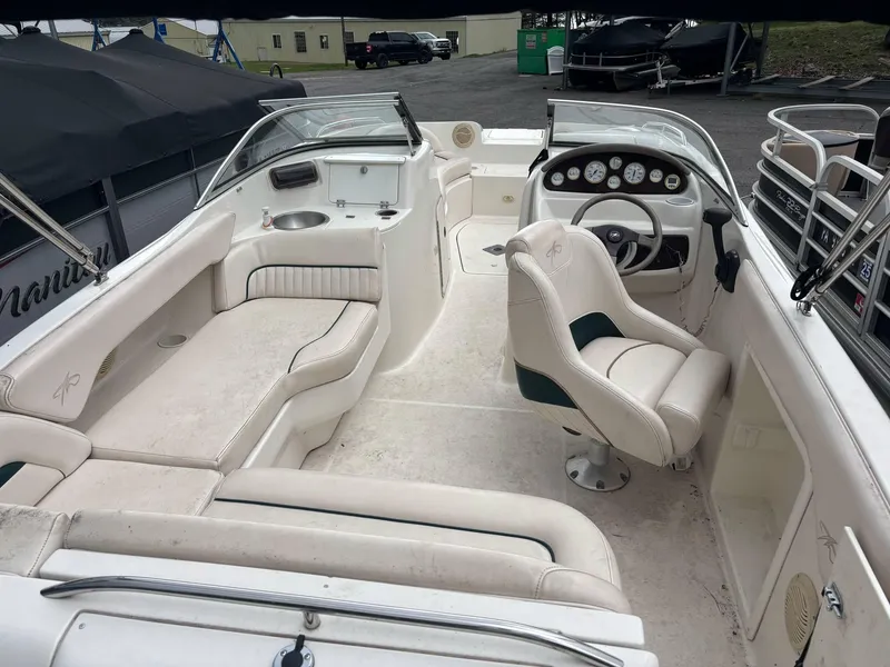 Slide: The Image of 2000 Monterey 220 Explorer boat interior with seating and steering console. - 4