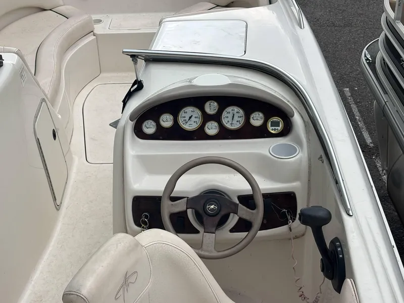 Slide: The Image of Steering console of a 2000 Monterey 220 Explorer boat with gauges and controls. - 5