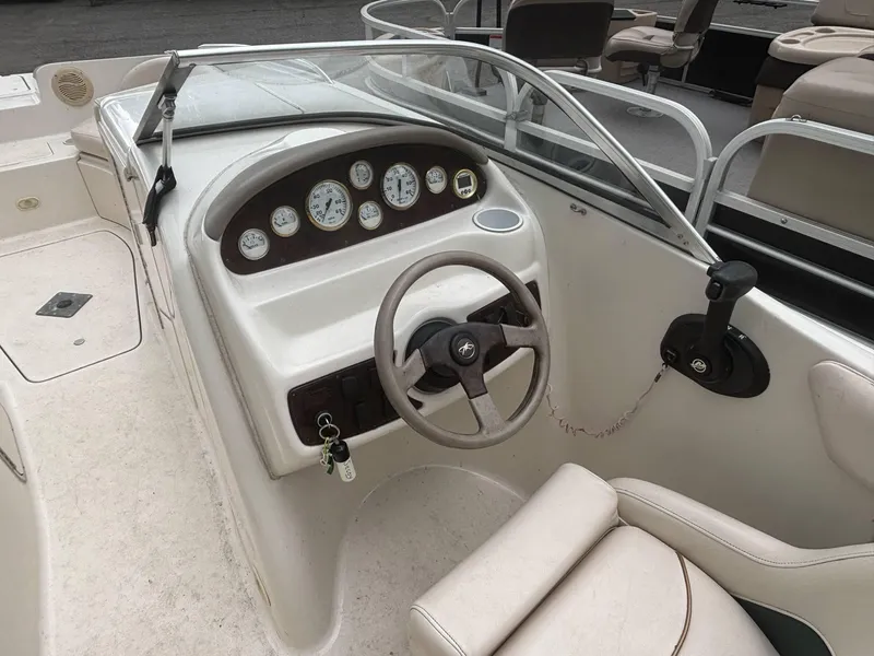 Slide: The Image of 2000 Monterey 220 Explorer boat dashboard with steering wheel and gauges. - 8