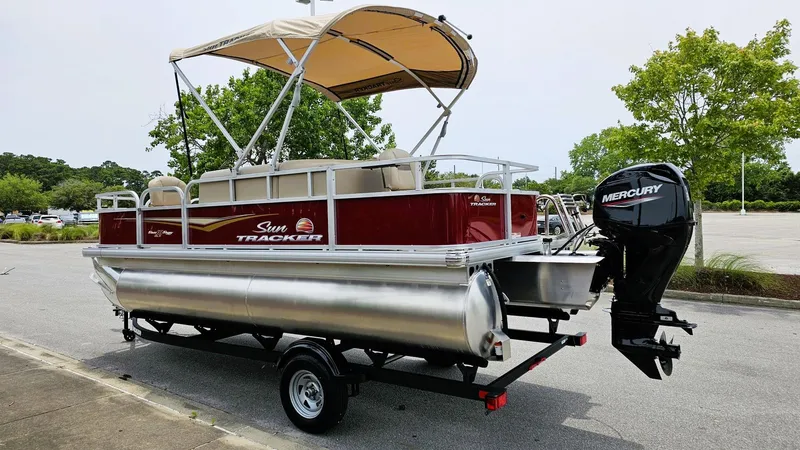 Slide: The Image of 2025 Sun Tracker Bass Buggy 18 DLX pontoon boat with Mercury engine on trailer. - 7