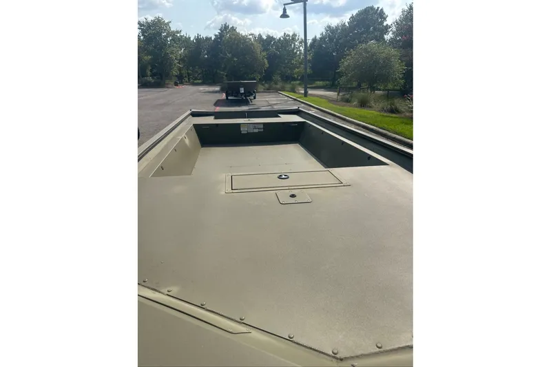 Slide: The Image of 2025 Tracker Grizzly 1860 Utility boat, spacious deck, parked outdoors on a sunny day. - 10