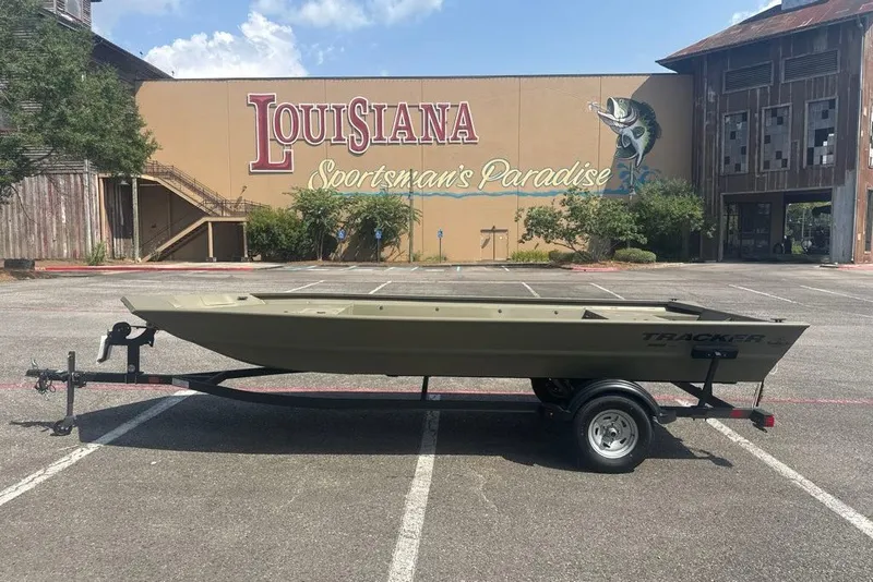 Slide: The Image of 2025 Tracker Grizzly 1860 Utility boat on trailer in parking lot. - 11