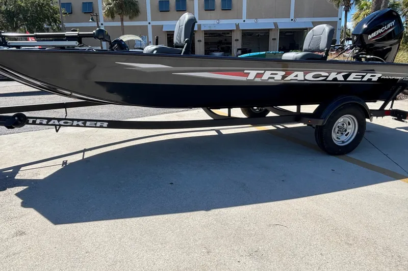 The Image of 2025 Tracker Panfish 17 boat on trailer, featuring sleek design and Mercury outboard motor. - 0