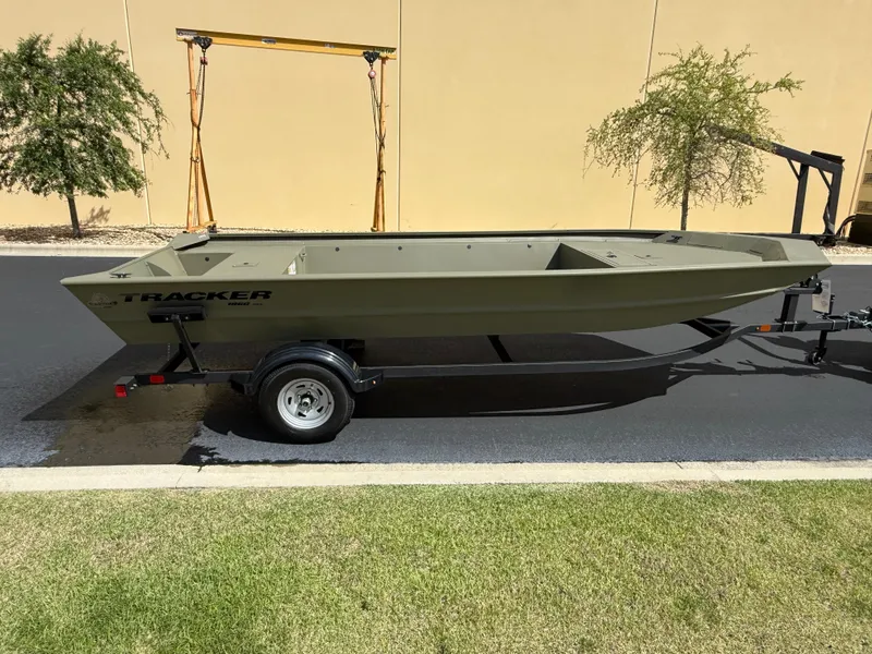 Slide: The Image of 2025 Tracker GRIZZLY 1860 Utility boat on trailer, parked outdoors. - 2