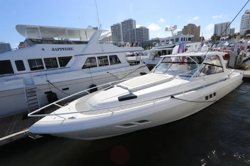 Slide: The Image of 2019 Intrepid 475 Sport Yacht docked at marina with city skyline. - 11